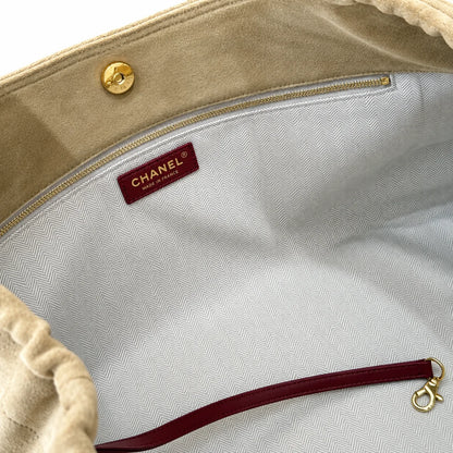 Inside view of beige quilted shoulder bag with herringbone lining