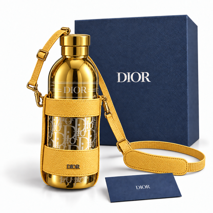 Yellow gold Dior Aqua bottle set with navy box and blue Dior card on white