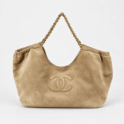 Beige quilted hobo shoulder bag front view on light gray background